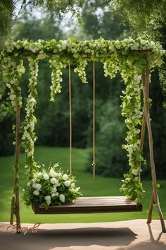 a wooden swing with flowers and greenery on it