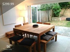 a wooden table sitting in the middle of a living room next to a sliding glass door