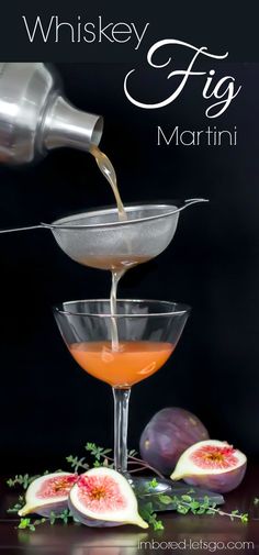 a glass filled with liquid sitting on top of a table next to sliced figs