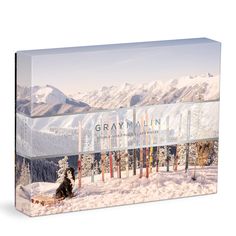 a box with an image of a dog in the snow on top of a mountain