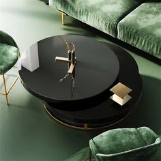 a black table sitting on top of a green floor next to two green velvet couches