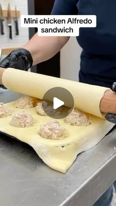 a person rolling dough on top of a counter