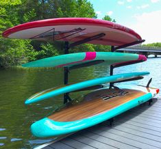 several surfboards are stacked up on the dock