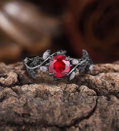 a red ring sitting on top of a rock