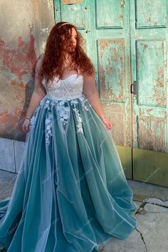 a woman standing in front of a door wearing a dress