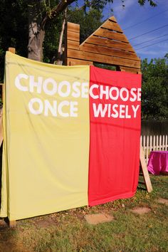 there are two banners that say choose wise and choose wise on the side of a house