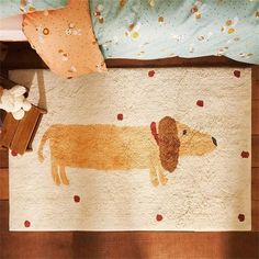 a dog rug on the floor next to a child's bed