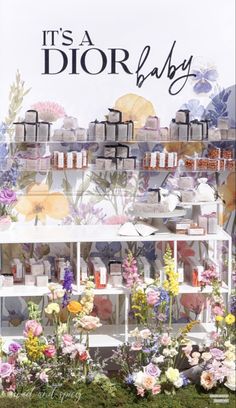 an advertisement for dior baby with flowers and candles on display in front of it