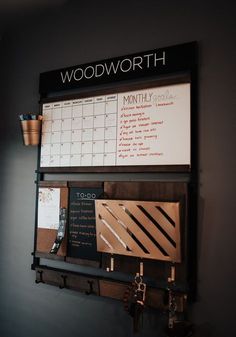 a wooden wall mounted calendar and key rack