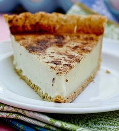 a piece of cheesecake sitting on top of a white plate with crumbs