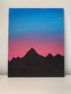 a painting of mountains against a pink and blue sky