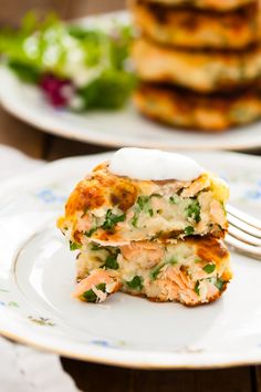 two white plates topped with food and a fork