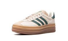 The Women’s adidas Gazelle Bold “Cream White/Collegiate Green” is a women’s-exclusive colorway of the retro sneaker with a stacked midsole and other modifications.  The adidas Gazelle Bold updates the original Gazelle silhouette with a triple-stacked gum rubber midsole, giving the sneaker a decidedly contemporary look.  The upper is complete with a cream suede construction with a tonal suede overlay on the toe.  Collegiate Green leather Three Stripes and gold “Gazelle” branding appear on the sid 2024 Shoes, Spring Fits