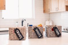 the kitchen counter is clean and ready to be used as storage for small items in baskets