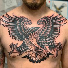 a man with a bird tattoo on his chest