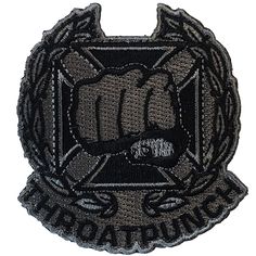 a black and grey patch with a fist on the front of it, that says operation