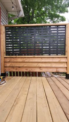 a wooden deck with a black screen on it