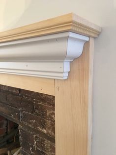 an unfinished fireplace with white paint on the mantle