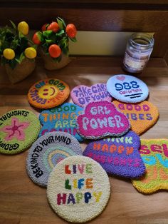 there are many colorful coasters on the table