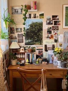 a wooden desk topped with lots of pictures and plants