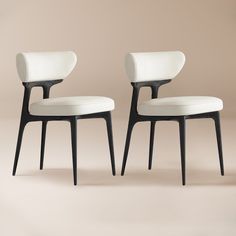 two chairs with white upholstered seats and black legs, side by side on a beige background