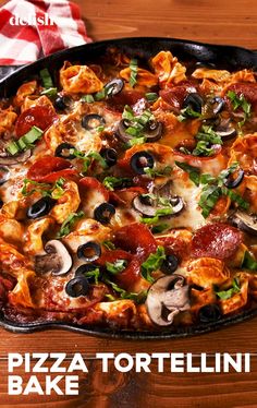 pizza tortellini bake with mushrooms, olives and pepperoni in a cast iron skillet