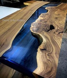 the table is made out of wood and has blue glass in it's center