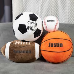 three different types of sports balls on a couch