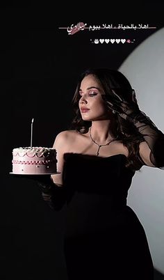 a woman in a black dress holding a cake with a candle on it and the words happy birthday written below