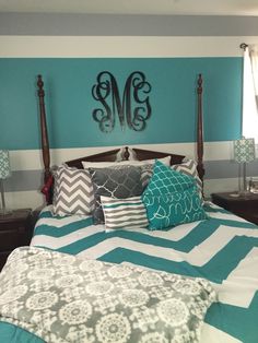 a bed with blue and white pillows in a bedroom