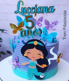 a birthday cake with a little mermaid on top and butterflies in the air above it