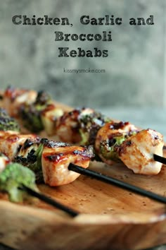 chicken, garlic and broccoli kebabs on a wooden platter