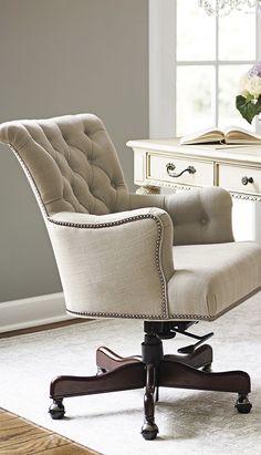 an office chair sitting in front of a desk with a book on top of it