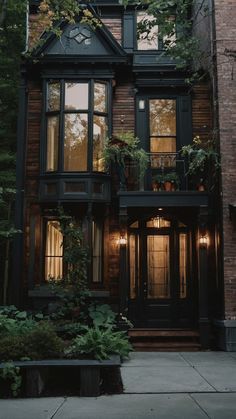 a large brown house with lots of windows