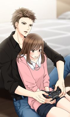 a man sitting next to a woman holding a game controller