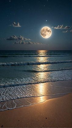 the full moon is shining brightly over the water at the beach with waves coming in