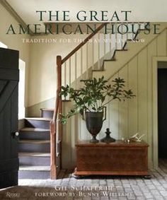 an entryway with stairs and potted plant on the floor in front of it