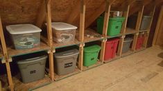 several storage bins are lined up in the attic