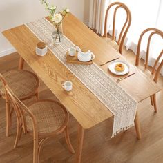 a wooden table with plates and cups on it