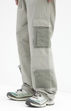 The Shadow Baggy Cargo Pants from PacSun offer a relaxed fit with wide legs, crafted from a durable cotton-nylon blend. Featuring a drawstring waistline, reinforced seams, side entry pockets, and cargo pockets with zipper details, these pants seamlessly blend practicality with contemporary style.


	Drawstring waistline
	Side pockets
	Welt back pockets
	Relaxed fit
	Cargo pockets with zip detail
	30" Inseam
	19.5" Leg opening
	Rigid
	66% Cotton, 34% nylon
	Machine washable
	Measurements taken from a size medium
	Model is wearing size medium
	Model Measurements: 6'2” Height, 30” Waist, 32” Inseam Casual Khaki Parachute Pants With Functional Pockets, Cotton Full Length Parachute Pants For Outdoor, Functional Cotton Cargo Parachute Pants, Casual Parachute Pants With Straight Leg And Functional Pockets, Casual Straight Leg Parachute Pants With Functional Pockets, Casual Straight Leg Parachute Pants With Pockets, Cotton Wide Leg Parachute Pants For Outdoor Activities, Spring Nylon Bottoms With Functional Pockets, Outdoor Full Length Cotton Parachute Pants