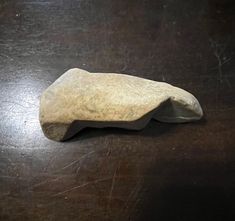 a rock sitting on top of a wooden table