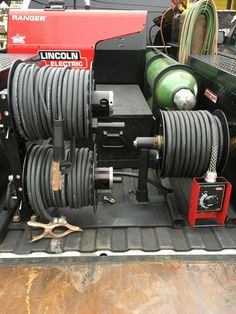 the back end of a truck with hoses and other equipment in the back compartment