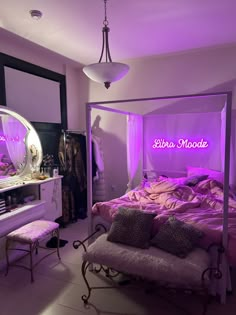 a bed room with a neatly made bed and purple lighting