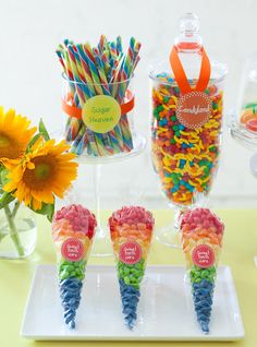 there are candy cones and sunflowers on the table with candies in them