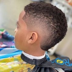 Check out the coolest black boys haircuts we have put together in our gallery. Here you will find a short curly hair mohawk with a fade, a low taper with curls, waves with a side part and many other trendy hairstyles for kids. #menshaircuts #menshairstyles #boyshaircuts #haircutsforboys #blackboyshaircuts Black Boys Mohawk Haircut Kids, Frohawk Fade Boys, Black Boy Fade Haircut, Curly Hair Fade Boys, Black Boy Haircuts Kids, Boys Haircut Black Kids, Black Boys Haircuts Kids Fade, Curly Hair Boys Haircut, Kids Mohawk Haircut