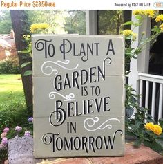 a sign that says to plant a garden is to believe in tomorrow