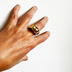 This was an exercise in patience. This ring is created out of a sheet of brass that I cut and split and wrapped back around. It's a sculptural and an unusual ring, but it's very comfortable to wear. About .75" wide at the bottom and varies around 1" at the top. Fabricated out of brass sheet and finished in 14k nickel free gold plate. Hand Forged Brass Open Ring, Gold Brass Dome Ring, Adjustable Wide Band Yellow Gold Ring, Unique Gold Brass Signet Ring, Unique Gold Hand Forged Rings, Minimalist Hand Cast Gold Rings, Adjustable Metal Wide Band Ring, Brass Open Ring With Unique Design, Adjustable Brass Wide Band Open Ring