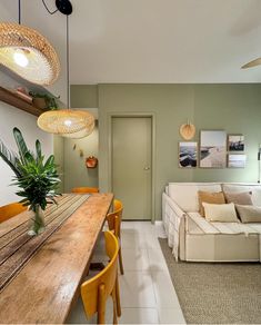 a living room filled with furniture next to a wooden table