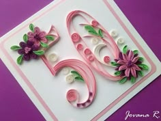 a close up of a greeting card with flowers and swirls on the number six