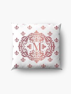 the monogrammed pillow is shown in pink and white with an ornate design on it